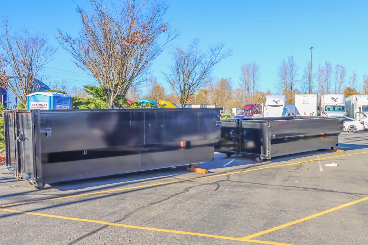 Professional dumpster rental service with roll-off container on residential driveway in Sand Springs